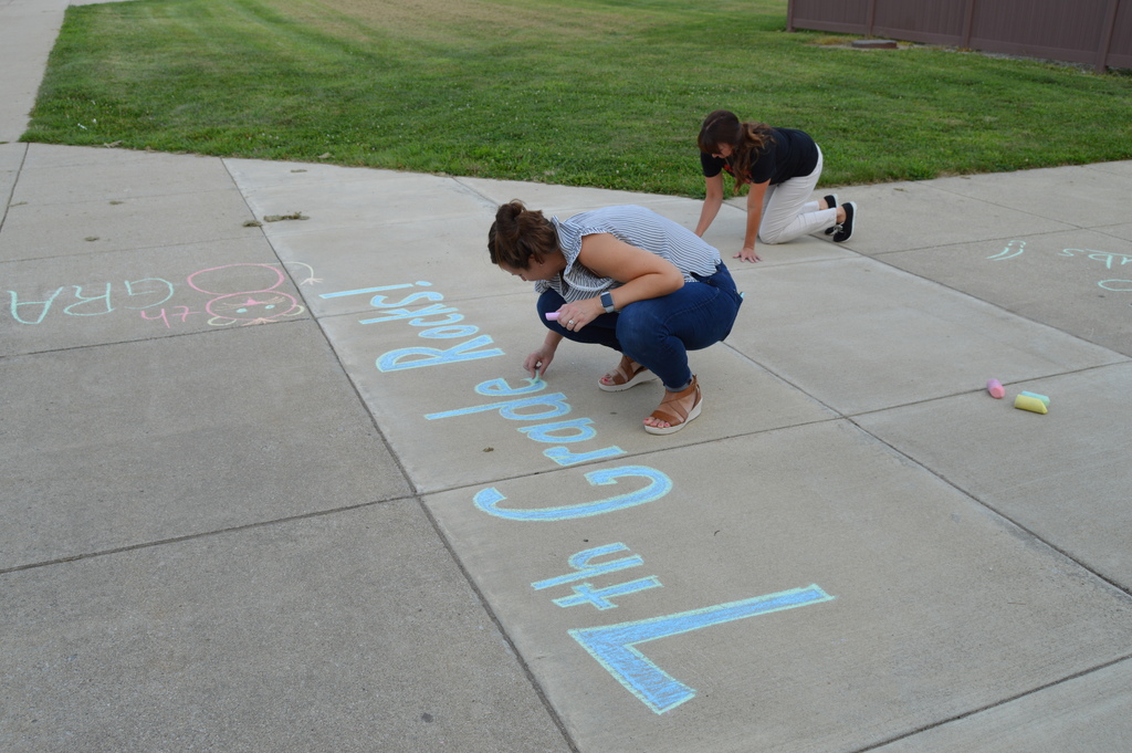 Teachers "Chalking the Walk" to welcome students back in the morning