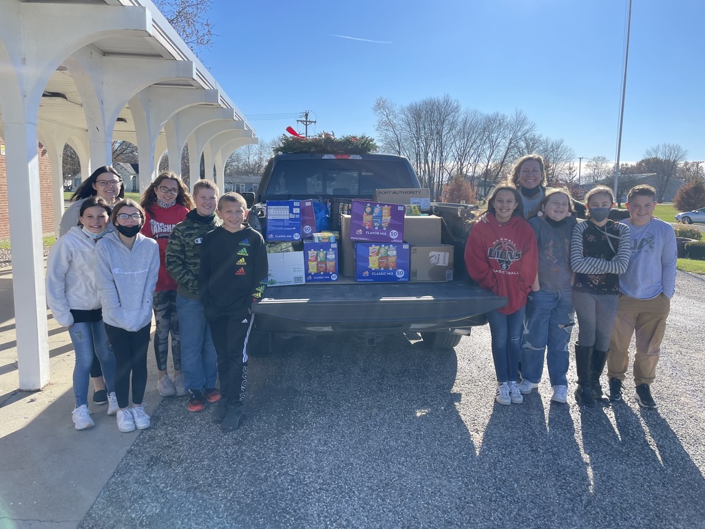 Students by  a truck of donated food.